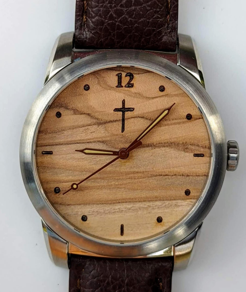 Watch with olive wood dial, leather strap, and cross design, ideal for memorial and personalization.