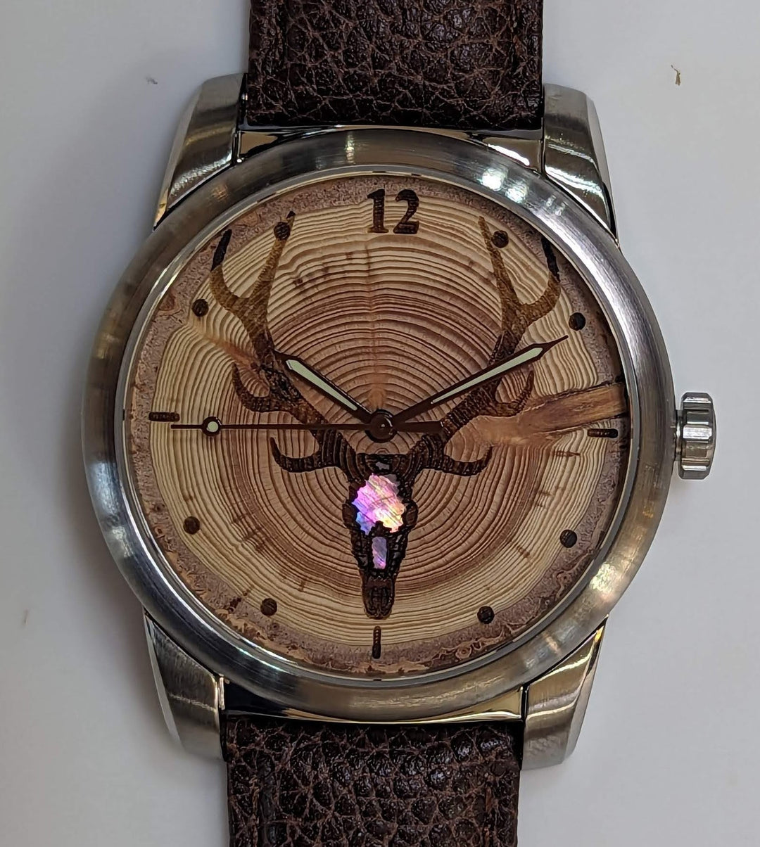 Tree Ring-Elk Watch featuring Douglas-fir dial and Mother of Pearl inlay, showcasing unique annual growth rings.