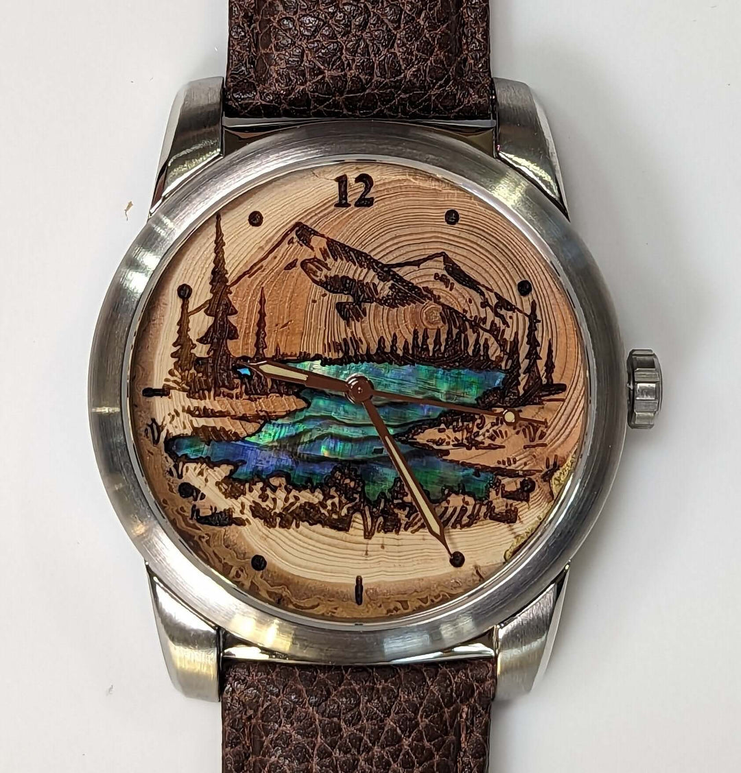 Handcrafted watch featuring Douglas-fir wood dial with mountain scene and mother-of-pearl inlay, perfect 5th anniversary gift.